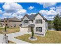 Charming two-story home with a well-manicured lawn and attached garage near the lake at 1861 Poplar Falls Ave, Lithonia, GA 30058