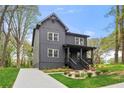 Modern two-story home with a covered porch, gray siding and a well-manicured lawn at 2869 4Th Sw St, Atlanta, GA 30315