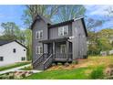 Modern two-story home featuring a covered porch with manicured front yard and landscaping at 2869 4Th Sw St, Atlanta, GA 30315