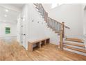 Bright foyer with wooden staircase, hardwood floors, and a built-in bench seating at 2869 4Th Sw St, Atlanta, GA 30315
