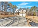Wide concrete driveway leading to a charming house with brick and siding at 4444 Sullivan Rd, Powder Springs, GA 30127