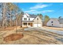 Stunning two-story house with white siding, brick accents, attached garage, and expansive front yard at 4444 Sullivan Rd, Powder Springs, GA 30127