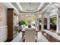 Formal dining room with coffered ceiling, hardwood floors, and large window view at 145 Cuthbert Ln, Acworth, GA 30101