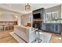 Cozy living room featuring a fireplace, modern furnishings, and hardwood floors at 165 2Nd St, Fayetteville, GA 30214