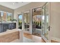 Bright living space with hardwood floors, glass doors to patio, and stylish wet bar with wine storage at 165 2Nd St, Fayetteville, GA 30214