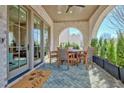 Charming outdoor patio with brick floor, seating area, and landscaped greenery at 165 2Nd St, Fayetteville, GA 30214