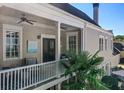 Relaxing outdoor balcony with comfortable seating, ceiling fans, and a view of the surrounding neighborhood at 4124 Hunt St, Covington, GA 30014