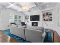 Elegant living room featuring a fireplace, built-in bookshelves, and coffered ceilings, perfect for relaxation at 325 Valley Brook Way, Atlanta, GA 30342