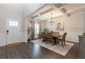 Elegant dining room features coffered ceilings, modern chandelier, and a dining set for sophisticated entertaining at 4824 Sultana Sw Way, Atlanta, GA 30331