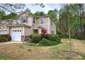 Attractive townhome featuring a manicured lawn and beautiful landscaping at 537 Rendezvous Rd, Acworth, GA 30102