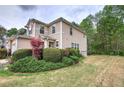 Exterior view of the townhome with a well-kept lawn and lush greenery at 537 Rendezvous Rd, Acworth, GA 30102