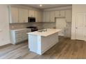 Modern kitchen with shaker cabinets, an island with bar seating, and stainless steel appliances at 122 Airmont Dr, Sharpsburg, GA 30277