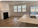 Bright living room featuring a fireplace, hardwood floors, and a seamless flow to the patio at 122 Airmont Dr, Sharpsburg, GA 30277
