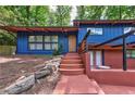 Stylish blue exterior with stone steps and a wooden door with a modern design at 3348 Lynnray Dr, Atlanta, GA 30340