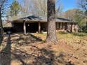 Traditional one-story brick home with a covered carport and mature trees at 5804 S South Gordon Sw Rd, Austell, GA 30168