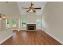 Bright living room featuring a stone fireplace, high ceilings, and wood floors at 20 Saddle Wood Dr, Dallas, GA 30157