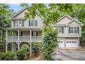 Two story traditional style home with a white front porch and two car garage at 314 Sable Trace Pass, Acworth, GA 30102