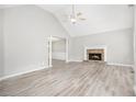 Bright living room featuring a cathedral ceiling, fireplace, and luxury vinyl flooring at 314 Sable Trace Pass, Acworth, GA 30102