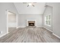 Bright living room featuring a cathedral ceiling, fireplace, and luxury vinyl flooring at 314 Sable Trace Pass, Acworth, GA 30102