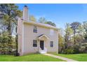 A view of the two-story home with siding and a well kept lawn and landscaping at 5228 Kirk Dr, Atlanta, GA 30349