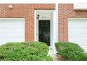 Inviting entryway with a black front door framed by white trim and brick facade at 809 Brickleridge Se Ln, Mableton, GA 30126