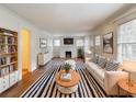 Bright living room featuring a fireplace, hardwood floors, and modern furniture arrangement at 2129 Fairhaven Ne Cir, Atlanta, GA 30305