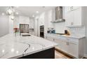 Modern kitchen with white cabinetry, stainless steel appliances, an island, and tile backsplash at 306 Atley Pl, Alpharetta, GA 30009