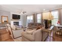 Bright living room with a fireplace, ceiling fan, hardwood floors, and sliding doors to a patio at 306 Atley Pl, Alpharetta, GA 30009