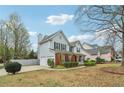 This two-story home with a brick facade features a side-entry garage and mature landscaping in a well-kept neighborhood at 4845 Weathervane Dr, Alpharetta, GA 30022