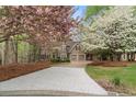 Lovely two-story home surrounded by flowering trees and mature landscaping at 525 Sycamore Pt, Woodstock, GA 30189