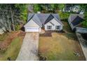 An aerial view of the lovely home showcasing its curb appeal, two-car garage, and well-kept lawn at 2643 Herndon Nw Rd, Lawrenceville, GA 30043