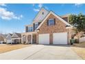 Charming two-story home with brick and siding, inviting front porch, and a two-car garage at 416 Pine Log Ct, Canton, GA 30115