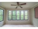 Sunroom with natural light entering through a bank of windows overlooking mature trees at 408 Smokerise Se Cir, Marietta, GA 30067