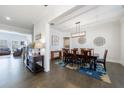 Open-concept dining room featuring hardwood floors and elegant decor adjacent to the living room at 4405 Croftshire Pl, Cumming, GA 30040