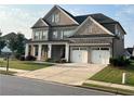 Charming two-story brick home with a well-maintained lawn and driveway leading to a two-car garage at 4405 Croftshire Pl, Cumming, GA 30040