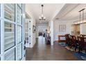 Elegant foyer featuring hardwood floors, modern lighting, and an open view into the dining room at 4405 Croftshire Pl, Cumming, GA 30040