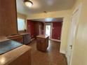 Cozy kitchen with appliances and a tile floor, featuring an island and wood cabinets at 675 Sowell Rd, Mcdonough, GA 30252
