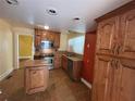 A functional kitchen featuring tile floors, stainless appliances, and wooden cabinetry at 675 Sowell Rd, Mcdonough, GA 30252
