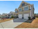 Traditional-style home with a large driveway and a two-car garage at 7937 Habanera Ln, Lithonia, GA 30058