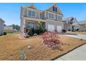 Two-story home features a well-maintained front yard and attached two-car garage at 7937 Habanera Ln, Lithonia, GA 30058