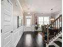 Welcoming foyer features hardwood floors, wainscoting, and a staircase at 7937 Habanera Ln, Lithonia, GA 30058