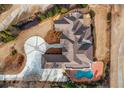 Aerial view showcasing the home's unique roofline, circular driveway, and backyard pool with spa at 1304 Marietta Country Club Nw Dr, Kennesaw, GA 30152