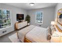 Cozy main bedroom with neutral tones and large windows offering wooded views at 160 Benjamin Cir, Fayetteville, GA 30214