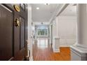 Inviting foyer with hardwood floors and elegant architectural details leads to the living area with a fireplace at 4100 Paces Se Walk # 2309, Atlanta, GA 30339