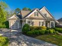 Beautiful single-story home with a large driveway and manicured landscaping at 6186 Talmadge Nw Run, Acworth, GA 30101