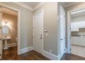 Hallway view showcases access to bathroom and laundry room with white cabinetry at 6186 Talmadge Nw Run, Acworth, GA 30101