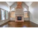 Spacious living room with vaulted ceiling, hardwood floors, fireplace and custom built-ins at 6186 Talmadge Nw Run, Acworth, GA 30101