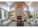 Elegant living room features a brick fireplace, custom built-ins, and large windows at 6186 Talmadge Nw Run, Acworth, GA 30101