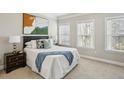 Serene bedroom featuring natural light from two windows and comfortable carpeted floors at 709 Bismark Ne Rd, Atlanta, GA 30324