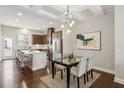 Modern kitchen with stainless steel appliances, a breakfast bar, and a dining area with stylish light fixture at 709 Bismark Ne Rd, Atlanta, GA 30324